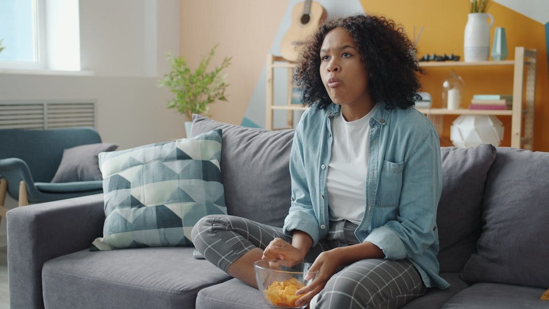 person binge watching tv on sofa